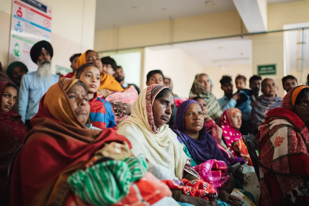 A group of women sitting on the floor as part of a workshop.