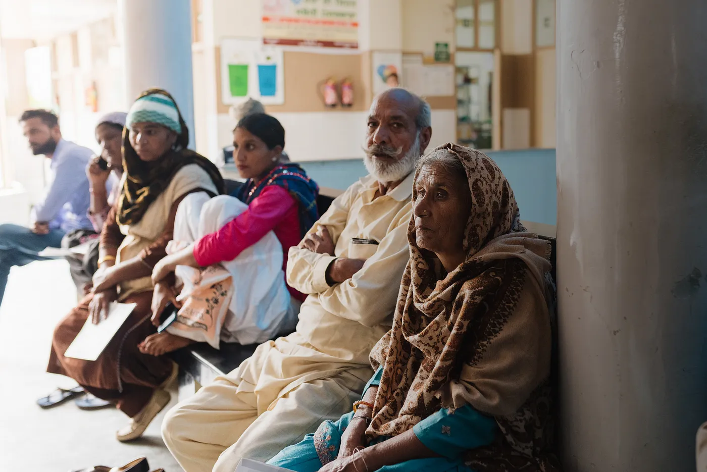 Caregivers wait outside a hospital in India