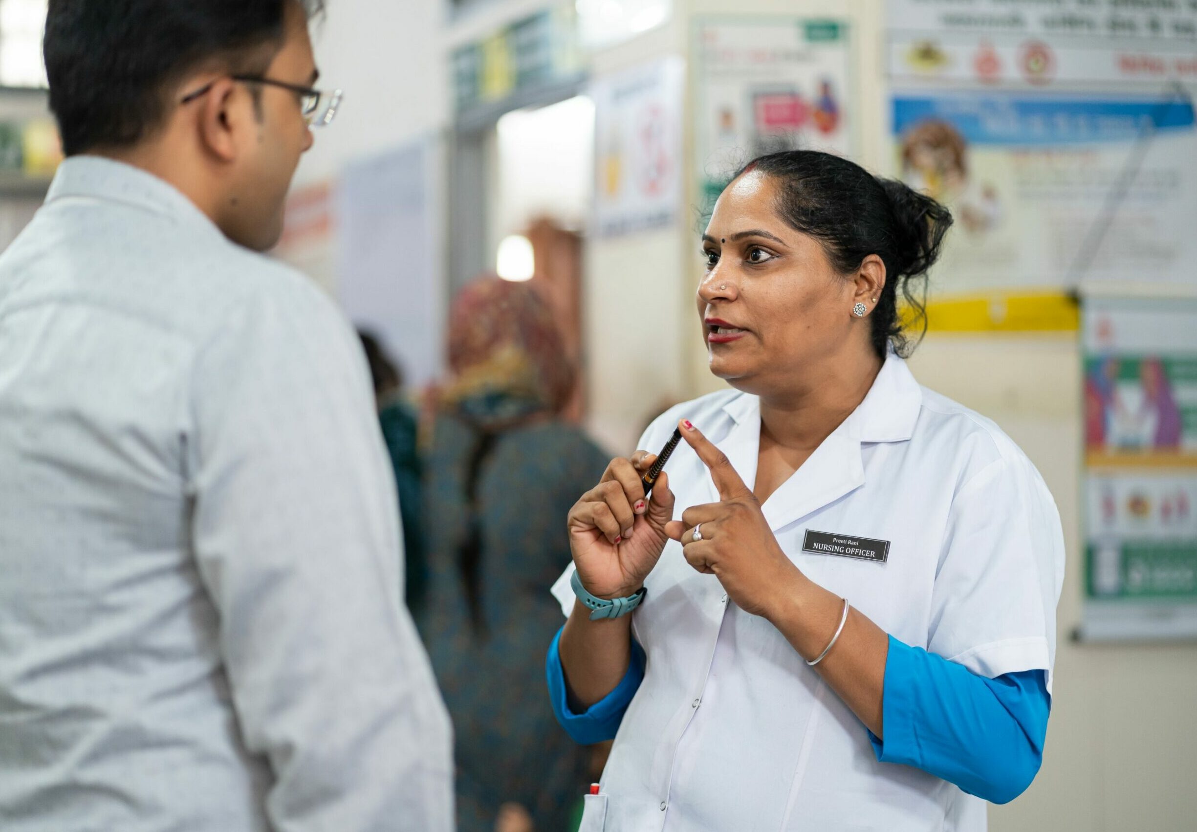A nurse talks to a man at a hospital in Haryana