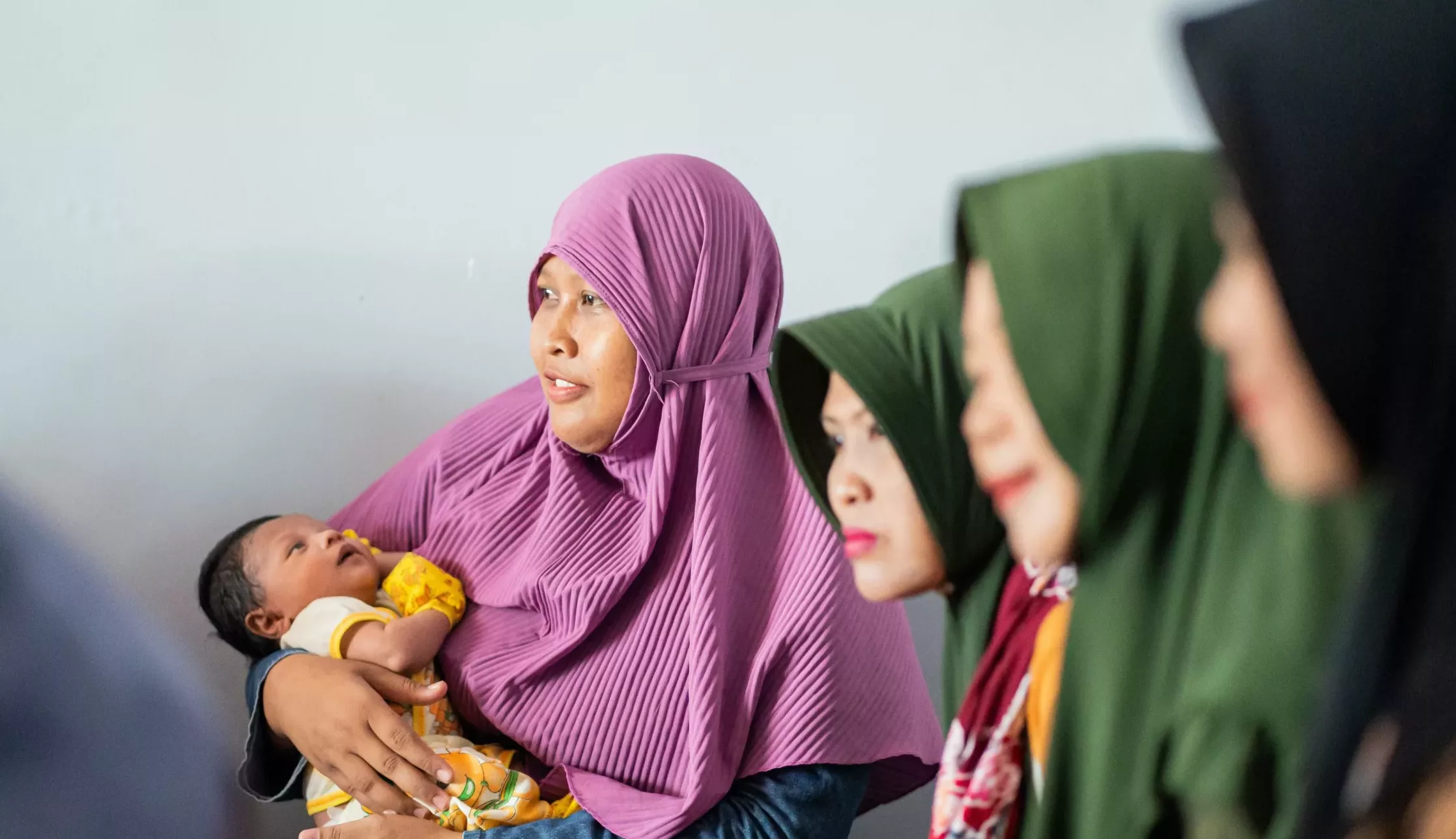 Kaders (community health workers) and new mothers convene at a trusted midwife’s home in Pamekasan, Indonesia.