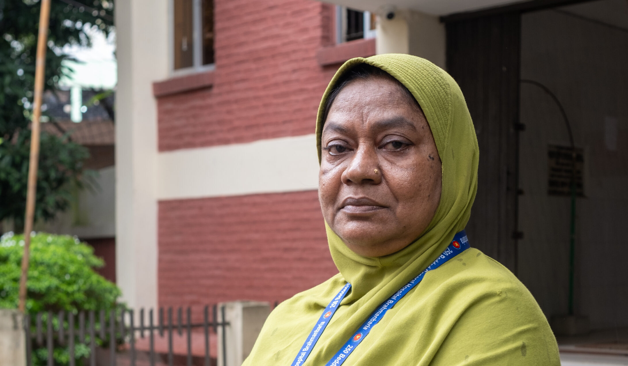 A profile of Mahamuda Begum standing outside a the hospital.