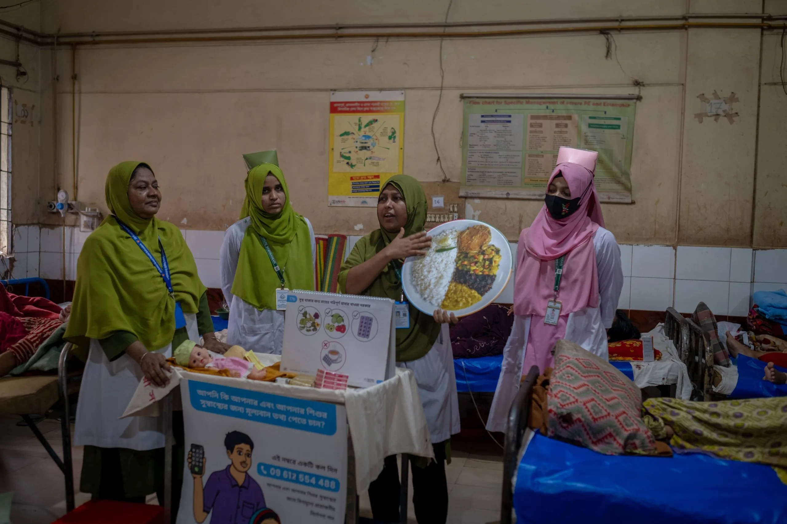 9. Mahamuda looks on as a nurse conducts a postnatal Care Companion Program session