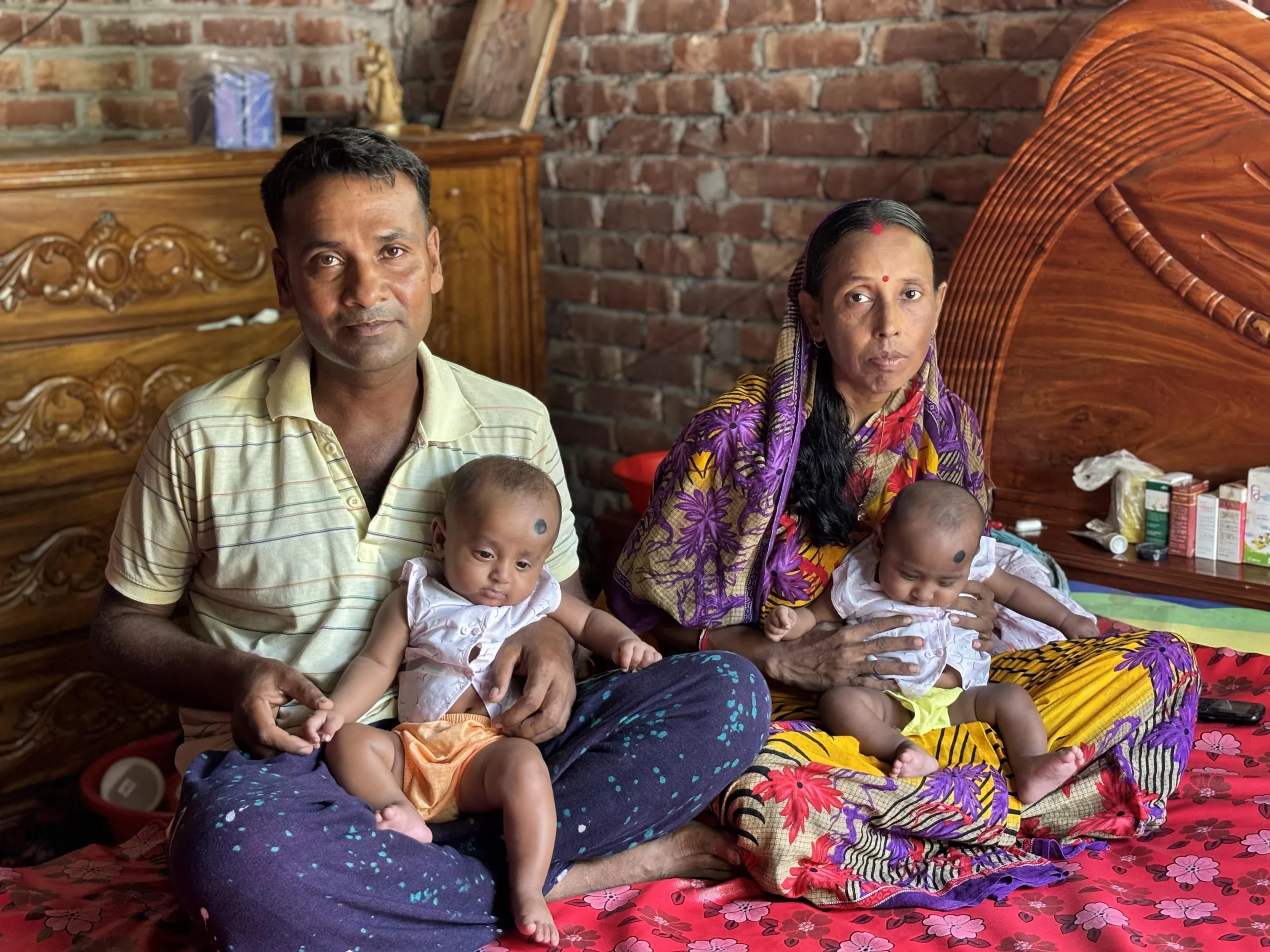 Uttam and Hoimonty hold their newborn twins.