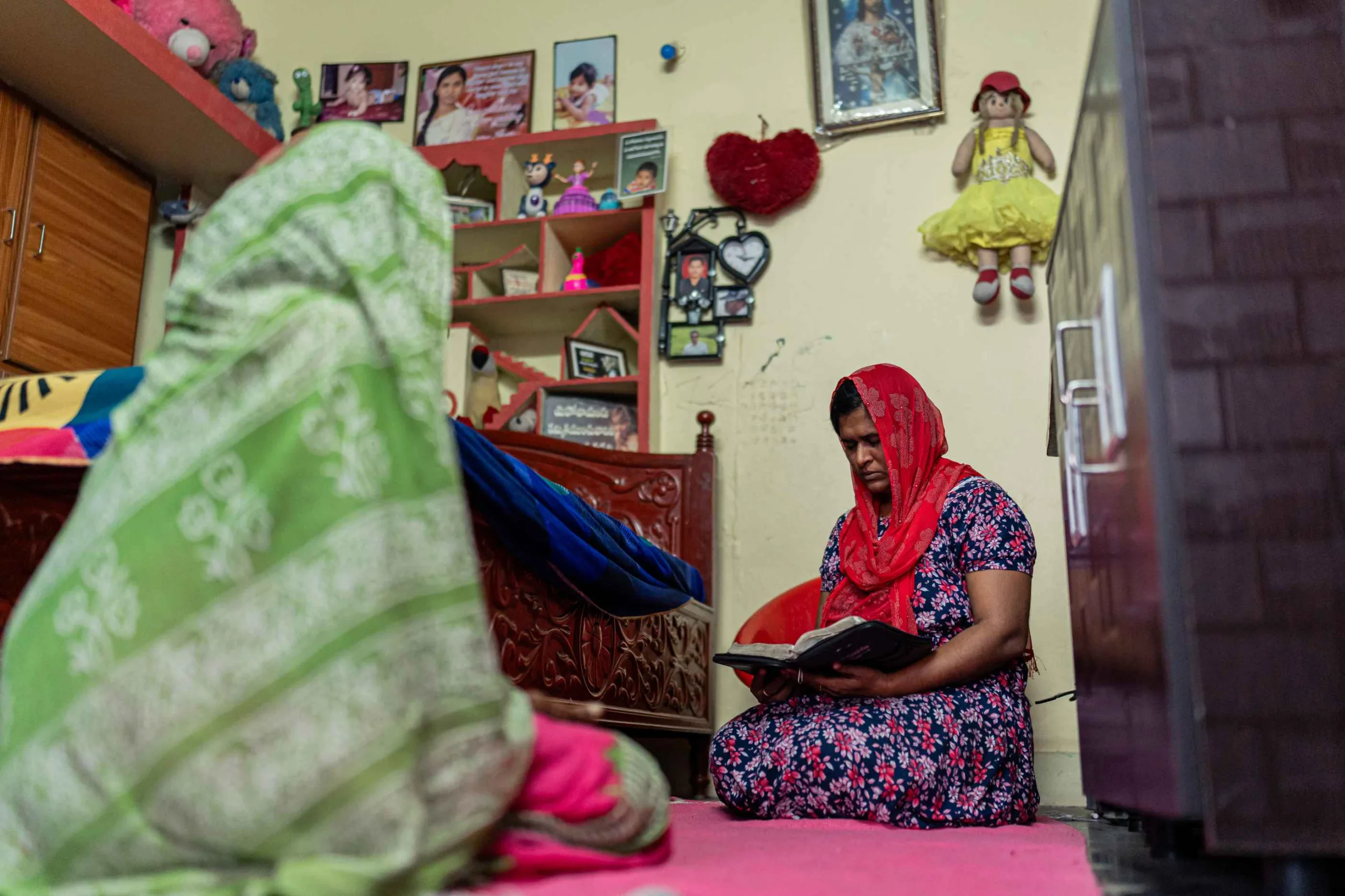 Before the day begins, Santhi and her mother kneel in quiet prayer.