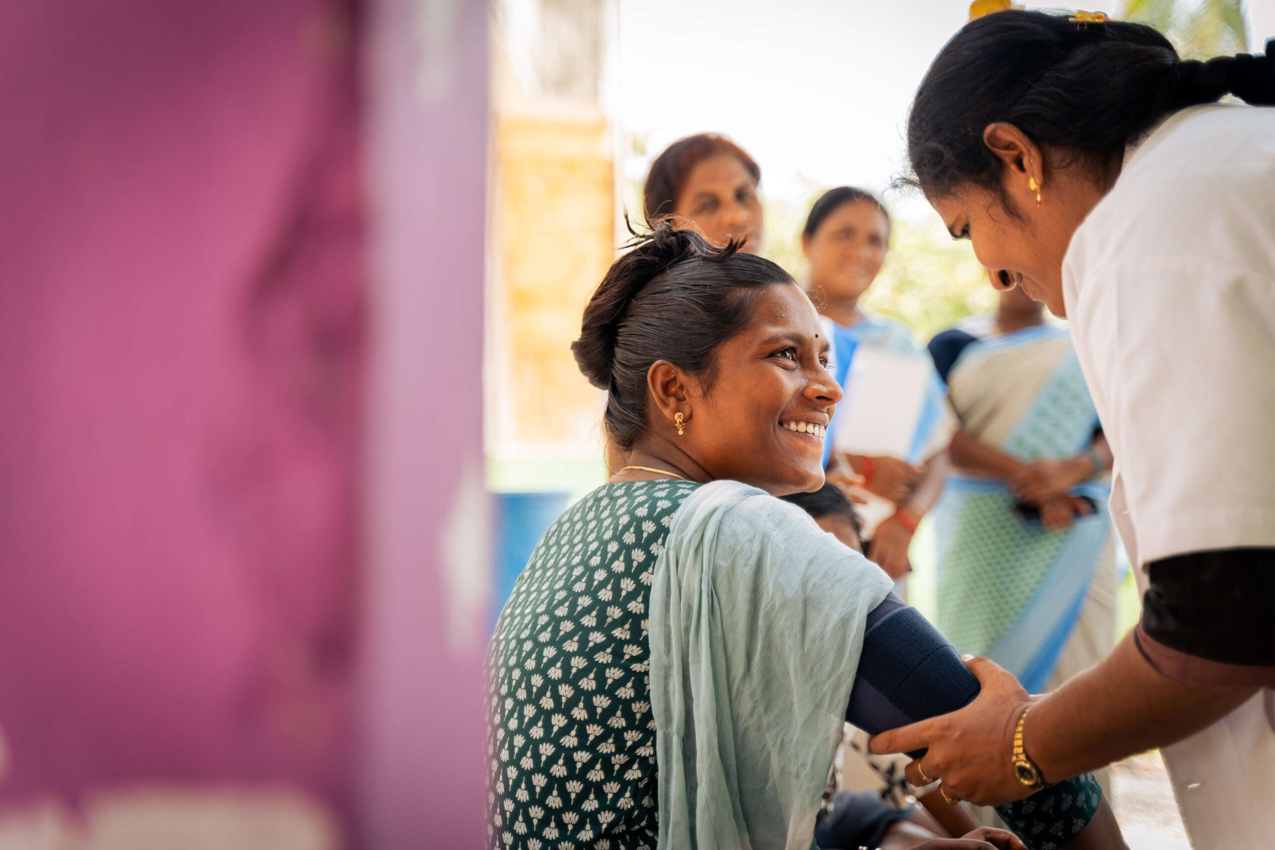 During a health check-up, Santhi and her patient share a light moment.