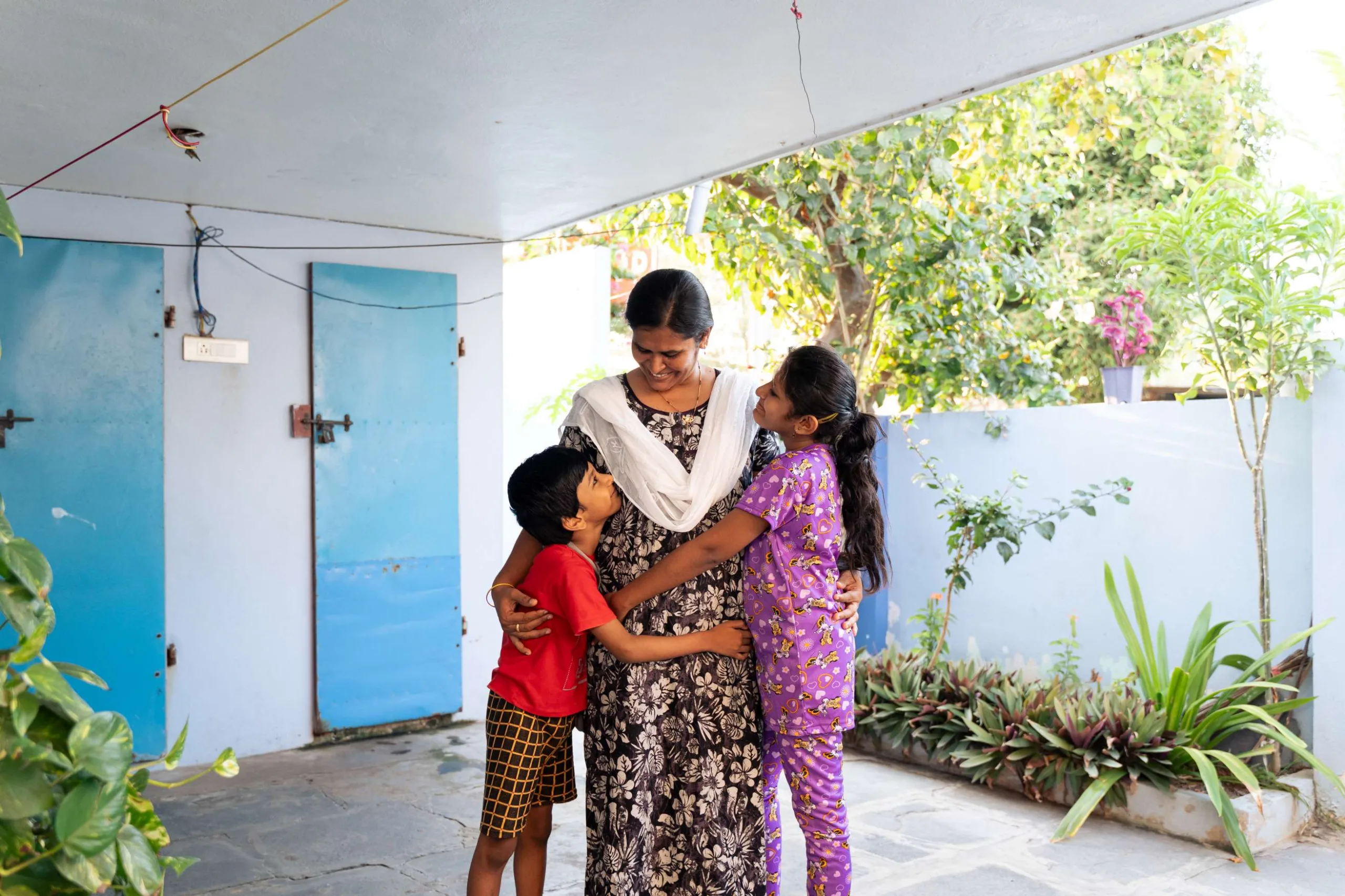After a long day, Santhi returns to warm hugs and smiles from her children.