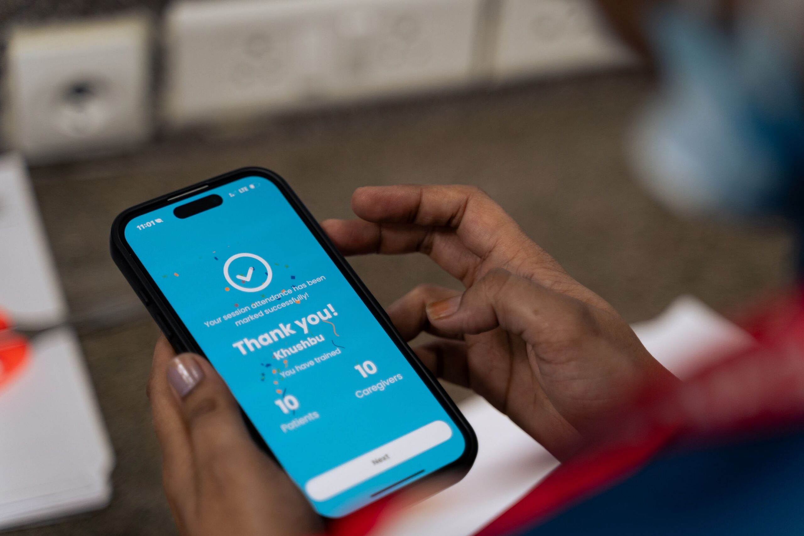 A healthcare worker uses the Care Companion App to record a session using her mobile.
